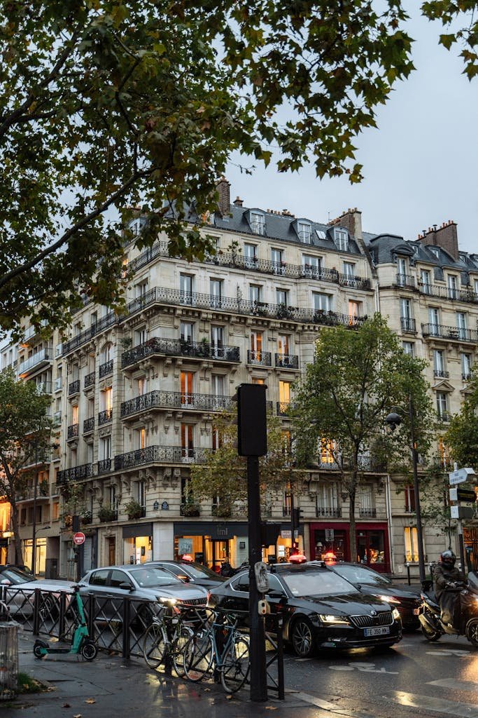 41 best Things to Do in Paris: Iconic Sights to Hidden Gems 27 Parisian street with elegant buildings and evening lights, capturing city's charm.