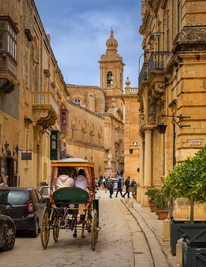 21 Best things to do in Mdina, Malta's Silent City 15 People enjoy a horse-drawn carriage ride on an ancient street in Mdina, Malta.