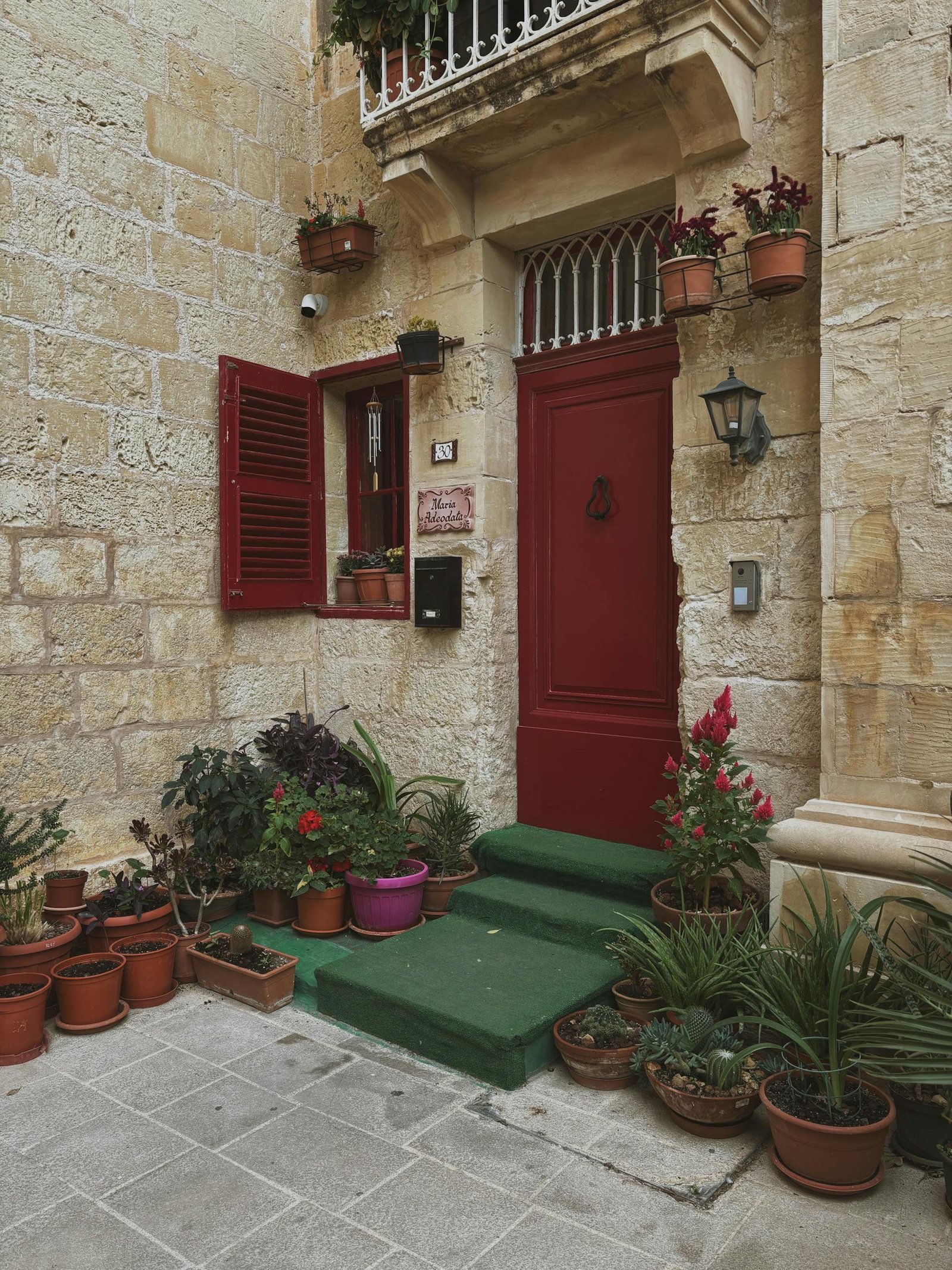 21 Best things to do in Mdina, Malta's Silent City 5 Picturesque entrance with vibrant plants and classic stone architecture in Mdina, Malta.