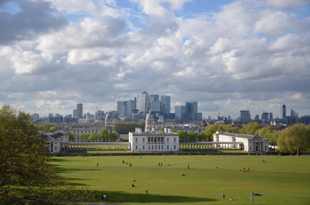 Scenic view of Greenwich Park with the historic Royal Observatory and modern London skyline.
