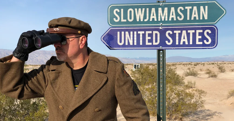 Man with the slowjamastan direction board