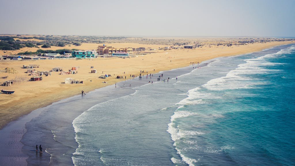 Stunning aerial view of Kund Malir Beach in Balochistan, featuring golden sands and vibrant blue sea.