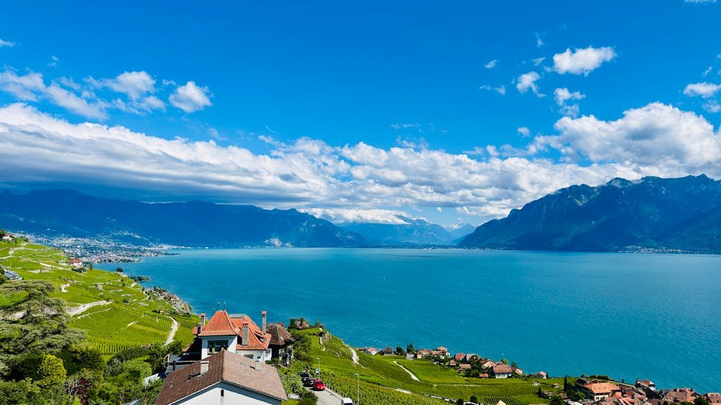 Stunning aerial view of Lake Geneva, vineyards, and mountains from Chexbres, Switzerland.