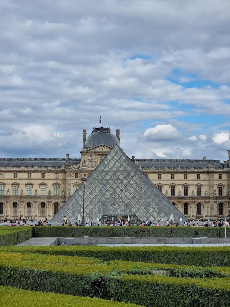 41 best Things to Do in Paris: Iconic Sights to Hidden Gems 4 Stunning view of the iconic Louvre Pyramid with the historic museum in Paris, daytime.