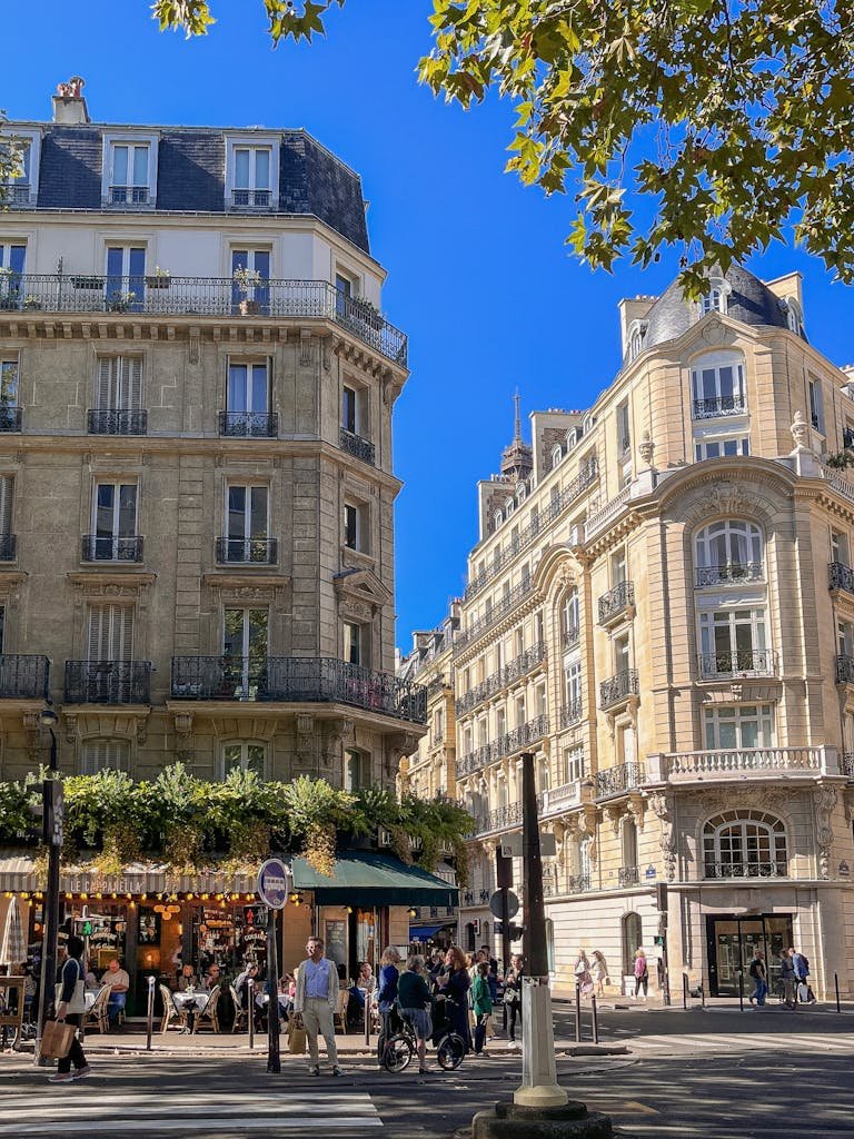 41 best Things to Do in Paris: Iconic Sights to Hidden Gems 15 Vibrant street scene in central Paris with historic architecture and bustling crowds.