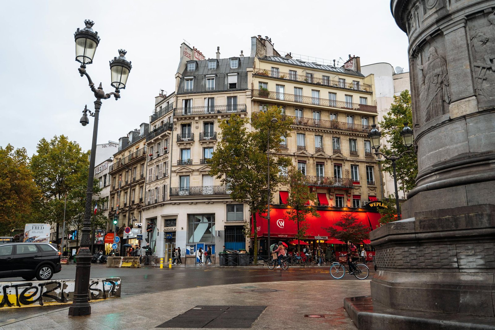 41 best Things to Do in Paris: Iconic Sights to Hidden Gems 1 Vibrant urban scene in Montmartre, Paris showcasing classic architecture and bustling street life.