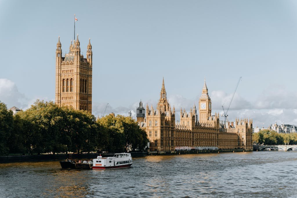 View of the iconic Houses of Parliament and Big Ben along the River Thames in central London.