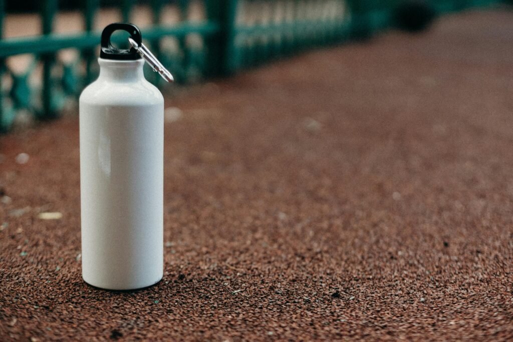 A white water bottle on a synthetic walking track