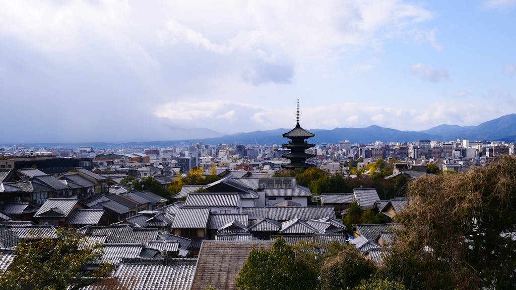 A breathtaking view of Kyoto city with traditional pagoda and modern skyline.