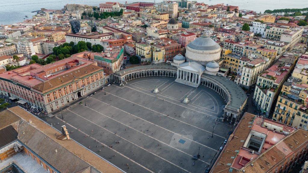 Is Naples Worth Visiting? 15 Pros + 5 Cons to visit Napoli 1 Aerial view of historic Piazza del Plebiscito in Naples, Italy with architectural landmarks.