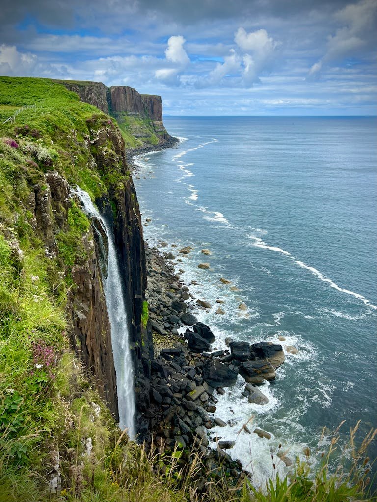 7 Day Scotland Road Trip Itinerary for First Timers 26 Breathtaking coastline view of Kilt Rock and Mealt Falls on the Isle of Skye, Scotland.