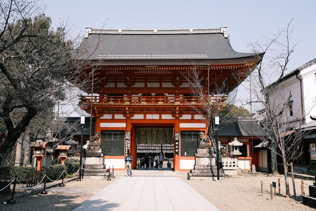 14 Best Things to Do in Kyoto, Japan + Travel Tips (2026) 7 Captivating view of the historic Yasaka Shrine in Kyoto, showcasing traditional architecture under a clear blue sky.