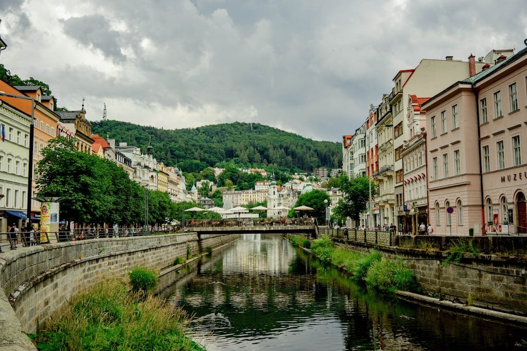 Charming view of Karlovy Vary, Czechia, showcasing historic architecture along a scenic canal.