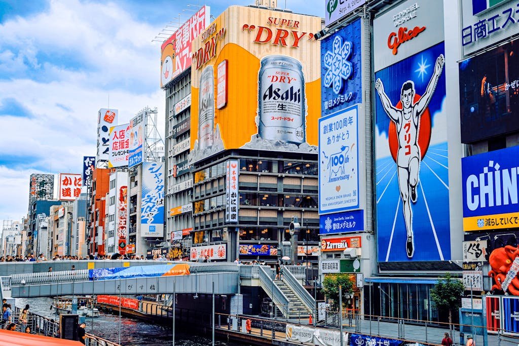 Colorful cityscape of Dotonbori's iconic signage along the canal in Osaka, Japan.
