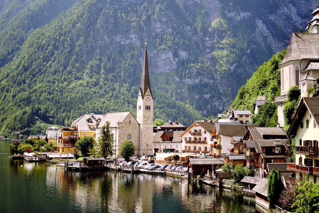 Discover the picturesque town of Hallstatt by the lake, surrounded by lush alpine landscapes.