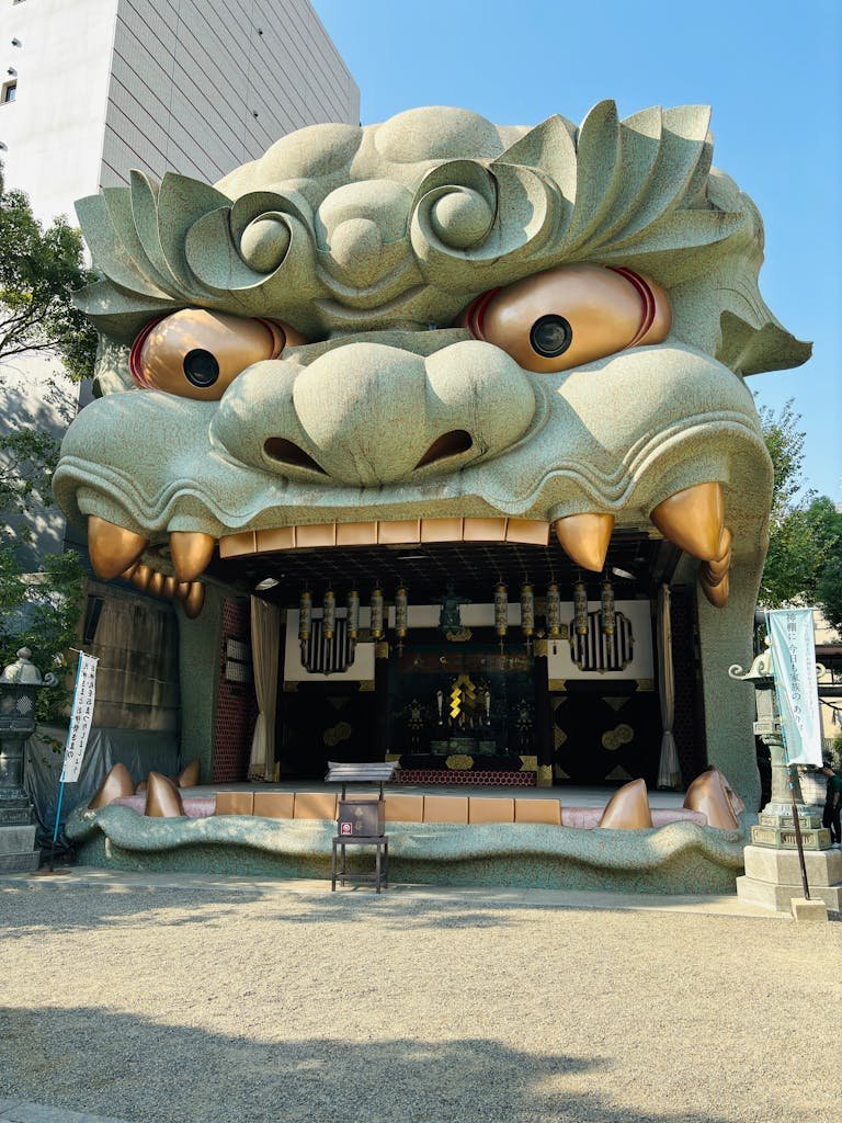 Dramatic dragon head entrance at Namba Yasaka Shrine in Osaka, Japan, showcasing traditional cultural art.