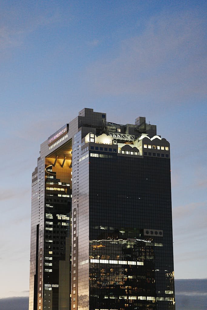 Evening view of the Umeda Sky Building in Osaka with clouds and reflections.