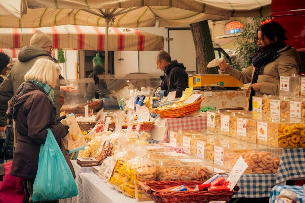Explore a bustling farmers market in Milan with vibrant stalls offering local pastries and goods.