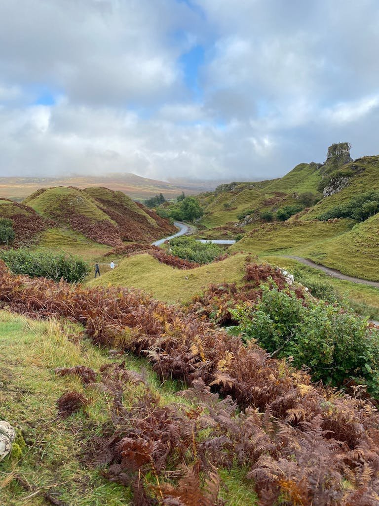 7 Day Scotland Road Trip Itinerary for First Timers 28 Explore the enchanting landscapes of Fairy Glen, Isle of Skye, with lush green hills and winding paths.
