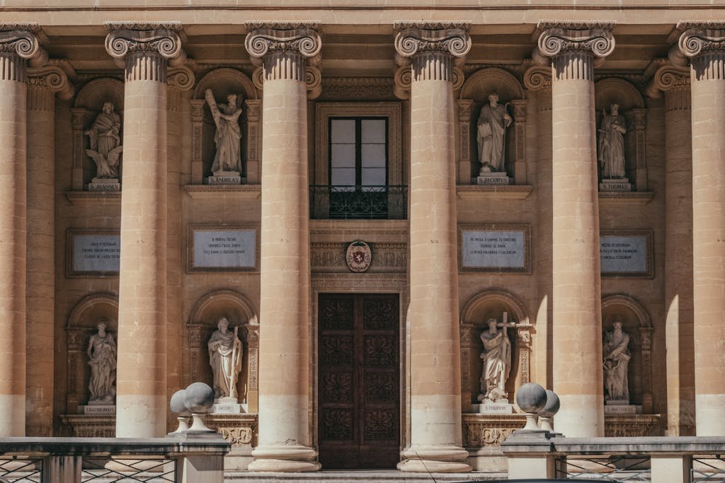 Is Malta Expensive? My Malta Budget Breakdown 2026 10 Front view of Mosta Rotunda's grand facade with columns and statues in Malta.