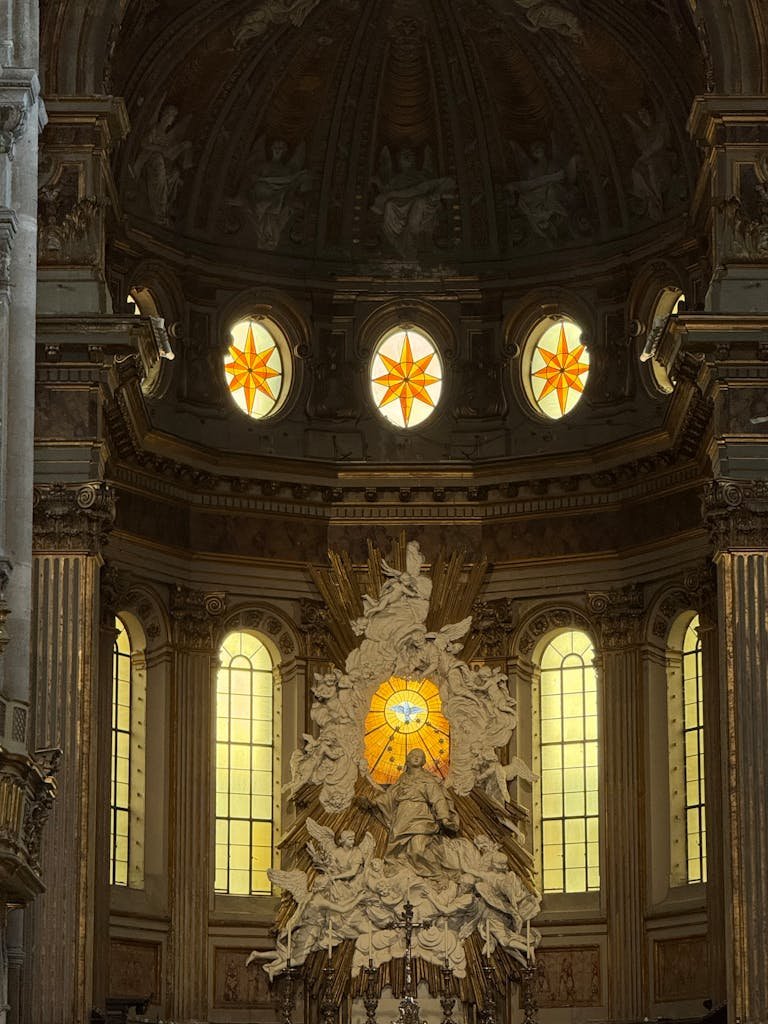 Intricate Baroque design inside Napoli's historic cathedral, showcasing rich history.