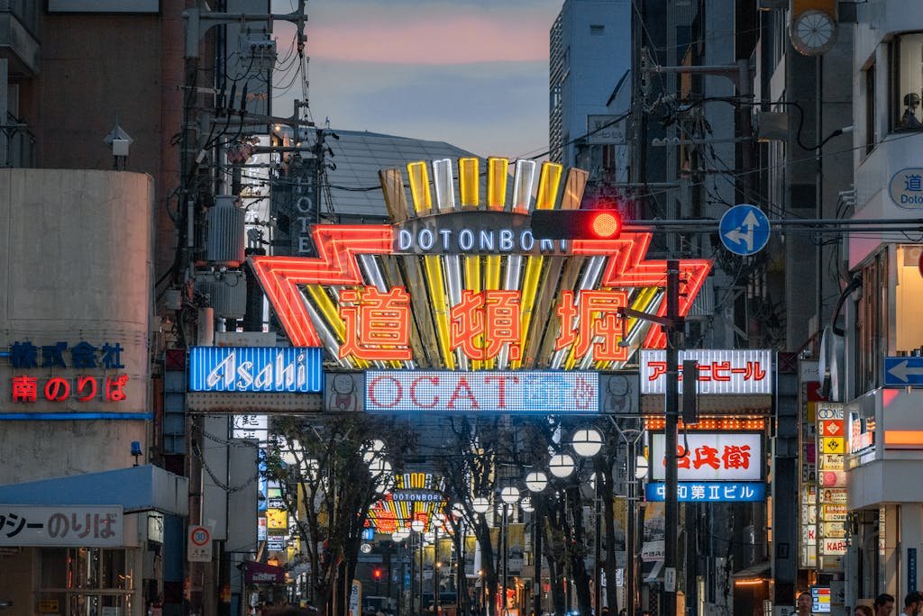 Lively neon-lit street scene capturing the iconic signs of Dotonbori in Osaka, Japan.