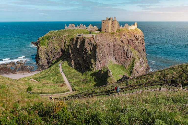 Scenic view of Dunnottar Castle perched on a cliff overlooking the North Sea in Scotland.