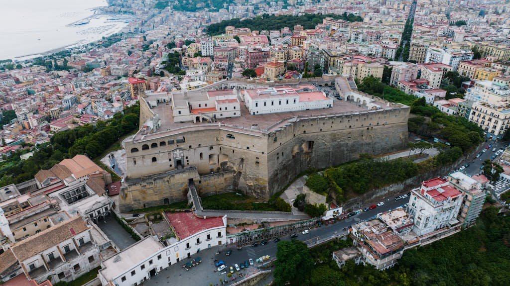 Stunning aerial view of Castel Sant'Elmo surrounded by the vibrant cityscape of Naples, Italy.