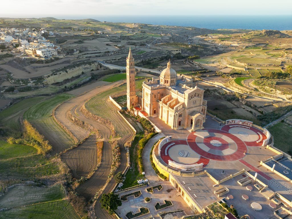 Is Malta Expensive? My Malta Budget Breakdown 2026 3 Stunning aerial view of the Basilica of Ta' Pinu set in the scenic landscape of Gharb, Gozo, Malta.