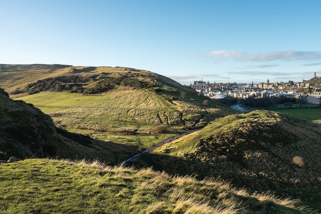 Stunning landscape view from Arthur's Seat overlooking Edinburgh city on a sunny day.