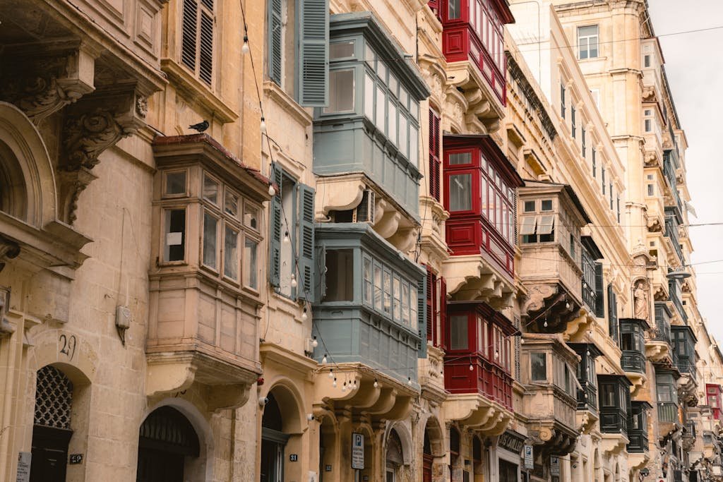 Is Malta Expensive? My Malta Budget Breakdown 2026 4 Traditional Maltese architecture showcasing colorful balconies in a street scene.