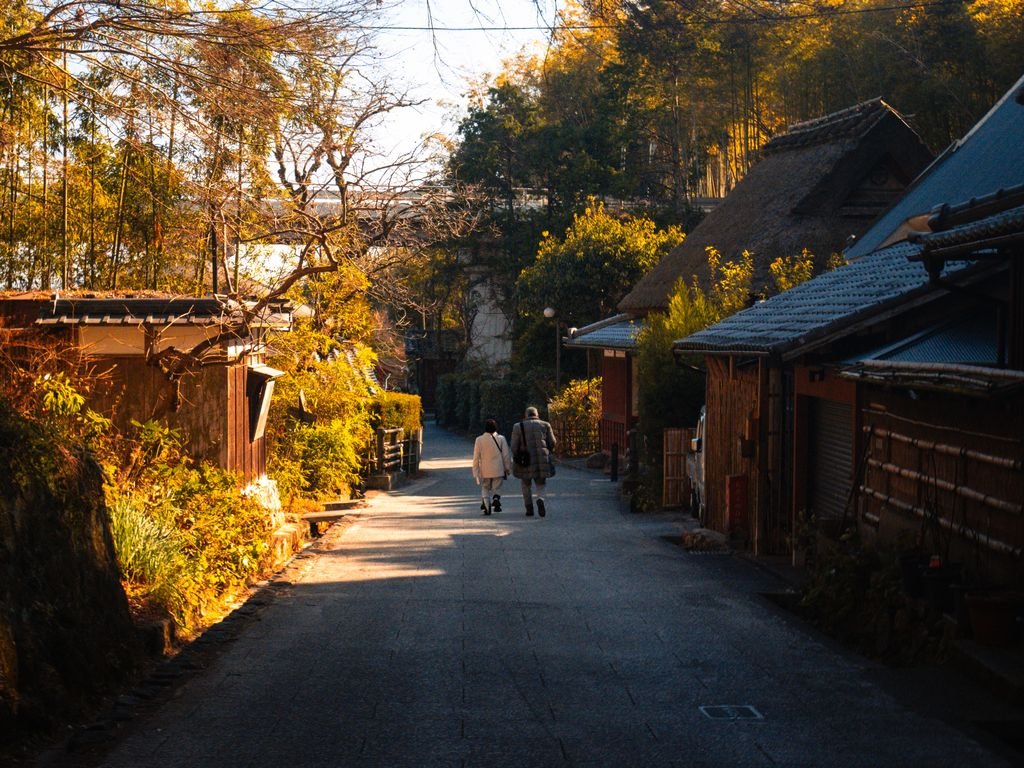 Arashiyama Bamboo Forest Kyoto: Is It Worth Visiting? 6 A serene evening scene of a quiet street in Arashiyama, Kyoto, Japan, with traditional houses and beautiful lighting.