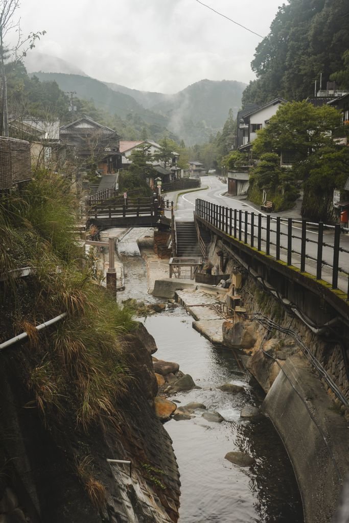 A tranquil view of a traditional onsen village in Tanabe, Wakayama, Japan during a misty day.