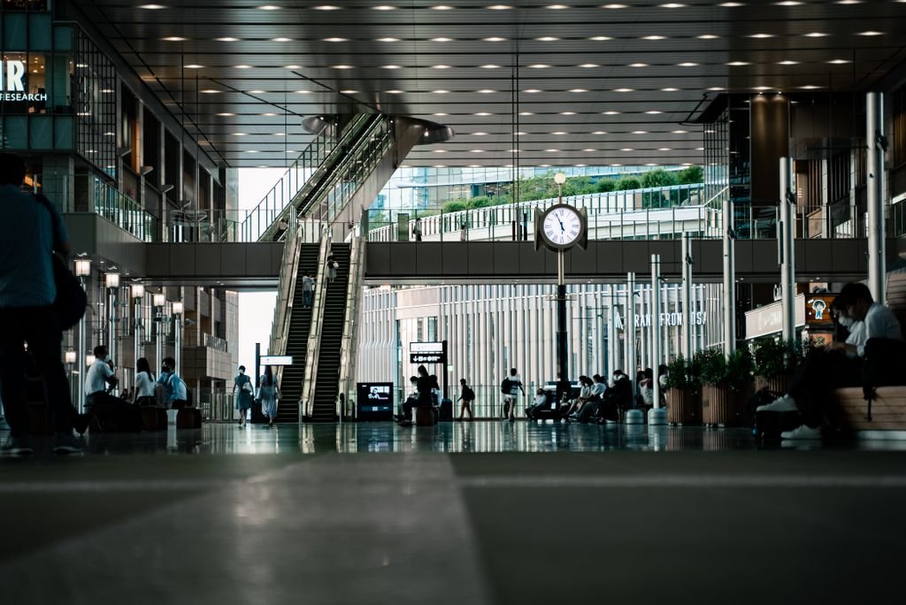Dynamic interior view of a busy train station in Osaka, Japan, capturing daily commuter life.