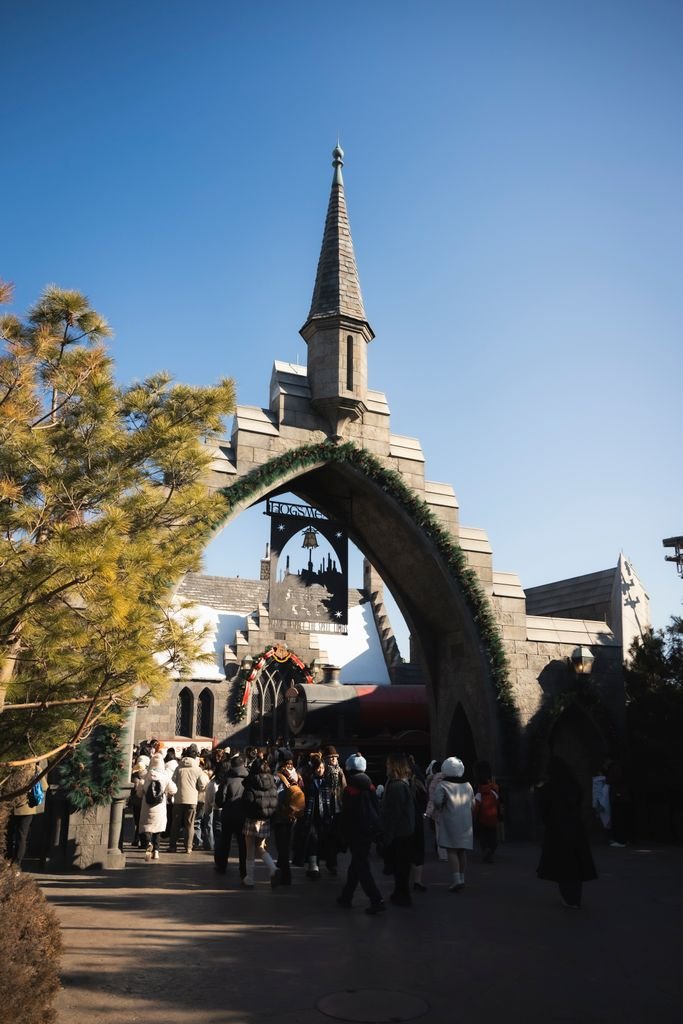 Universal Studios Japan: The Complete Guide for First-Time Visitors 10 Image of a theme park entrance with medieval-style architecture under a clear blue sky.