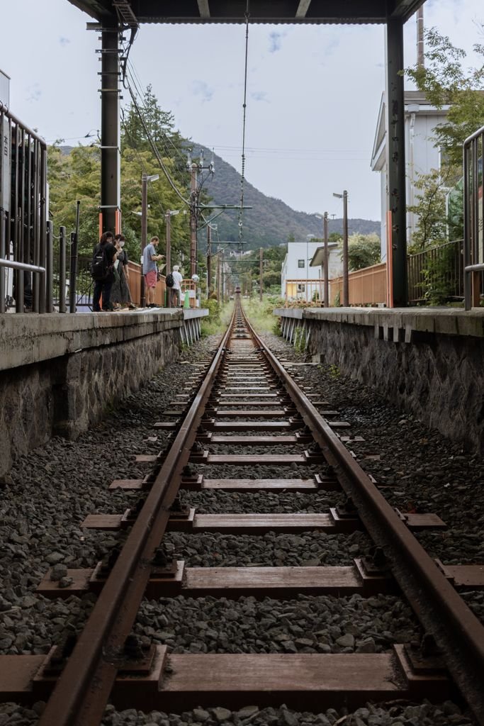 Railway tracks at Hakone train station with a picturesque background. Ideal for travel and transportation themes.