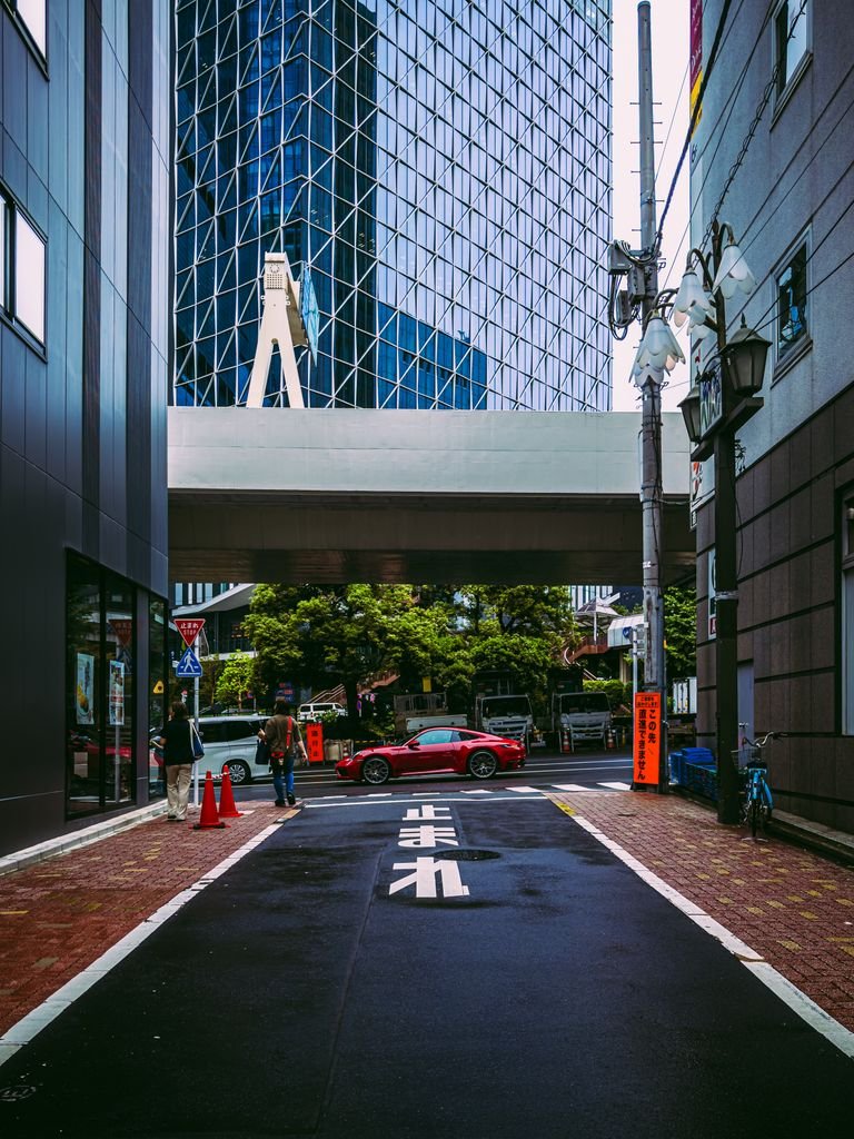 Street view in Shibuya, Tokyo featuring modern architecture and city life.