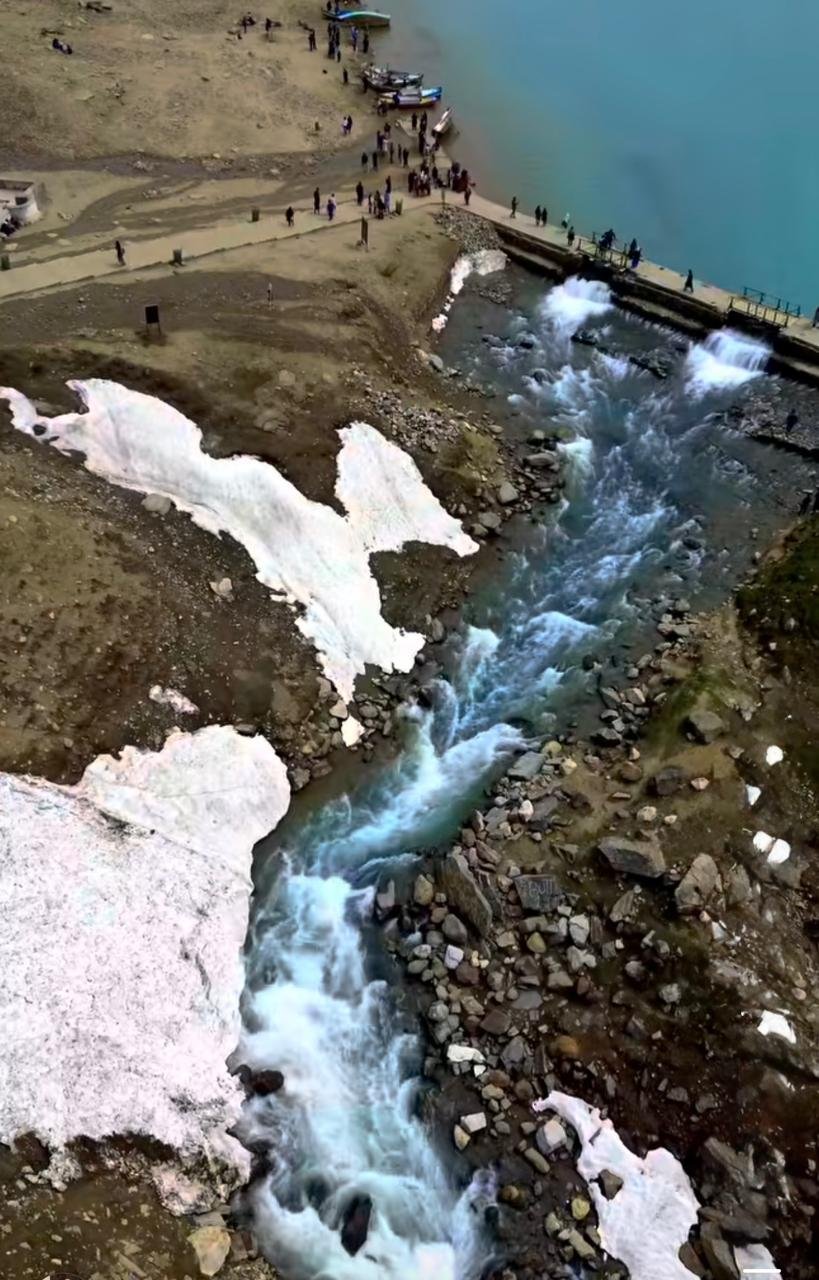 Lake Saif-ul-Malook with crystal clear turquoise water and snow covered mountains in Naran Valley