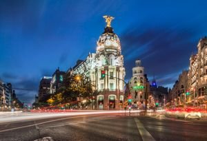 15 Free Things To Do In Madrid: A First Timer's Guide 1 A stunning night view of the Metropolis Building with light trails and vibrant city lights in Madrid.