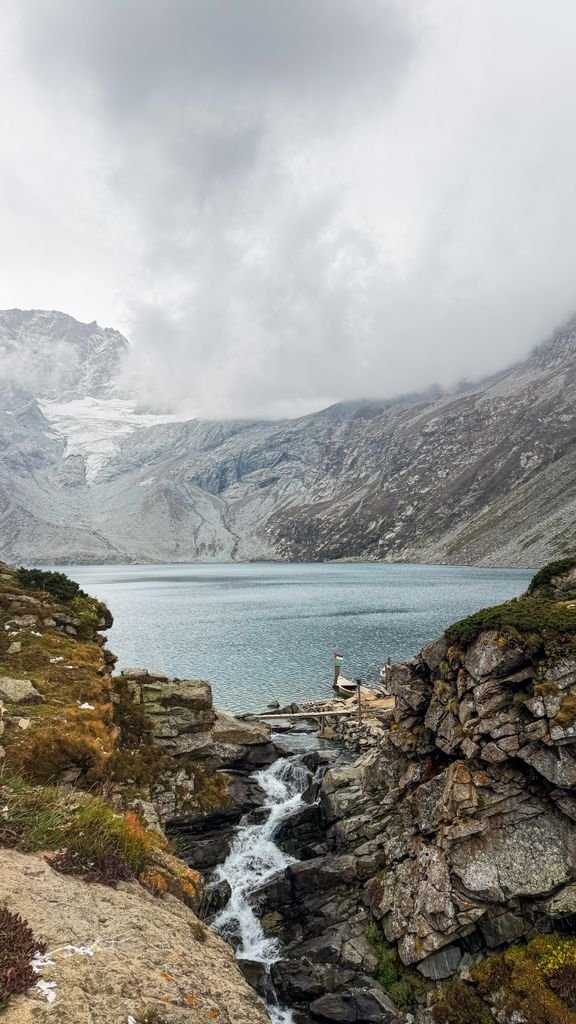 Discover the serene beauty of a remote mountain lake nestled in Pakistan's rugged landscape.