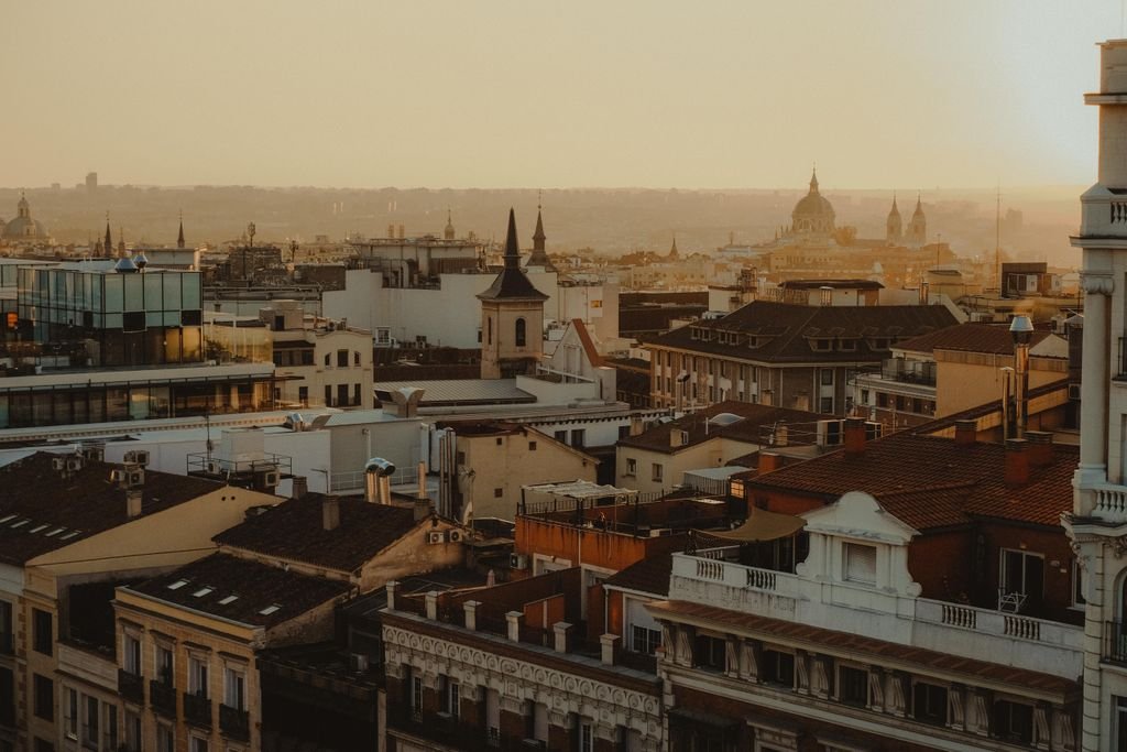 15 Free Things To Do In Madrid: A First Timer's Guide 2 Scenic panorama of Madrid's rooftops and skyline at sunset.