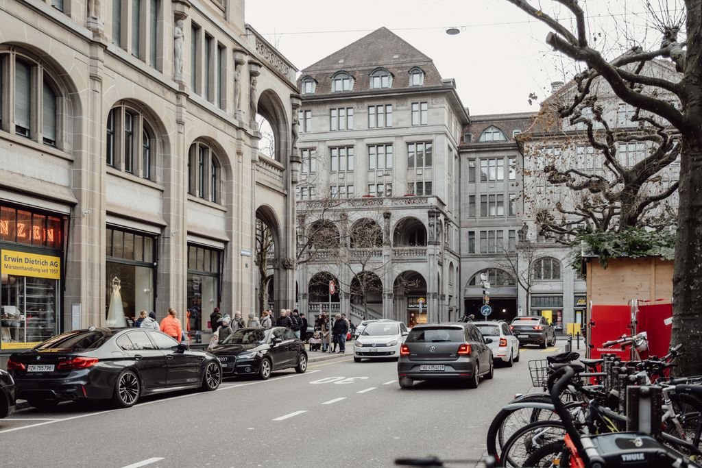 Explore the vibrant street life and historic architecture of Zurich, Switzerland in this captivating photo.